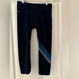 Mid calf black Aviator Nation legging with blue stripes on one leg. Super soft!